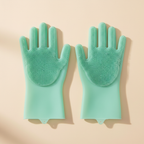 Mint green silicone grooming gloves for dogs on beige background