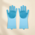 Blue silicone grooming gloves for dogs on beige background