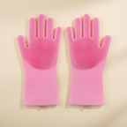 Pink silicone grooming gloves for dogs on beige background