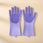 Purple silicone grooming gloves for dogs on beige background