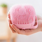 Person holding pink silicone dog bath brush